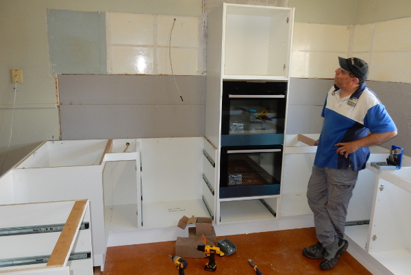 John Polvere with wall-oven cabinet just installed